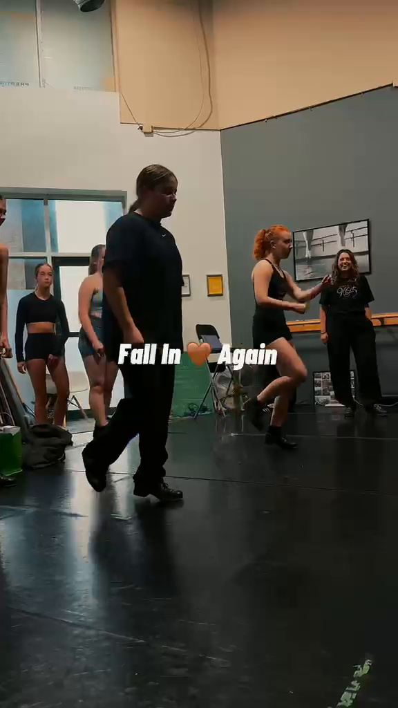 Dancers moving through a rehearsal sequence